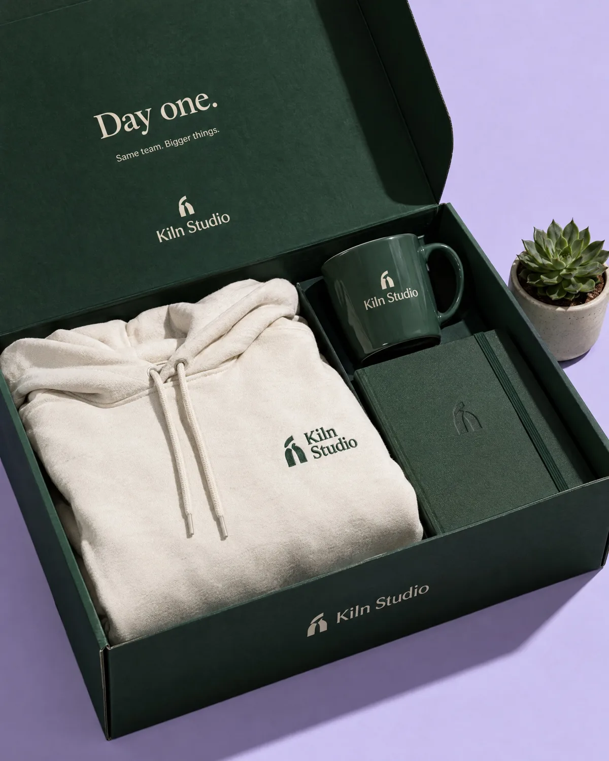 Onboarding box with a hoodie, mug and notebook