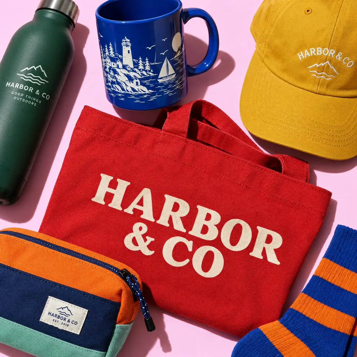 Red Harbor & Co tote with a mug, bottle, cap, socks and a pouch