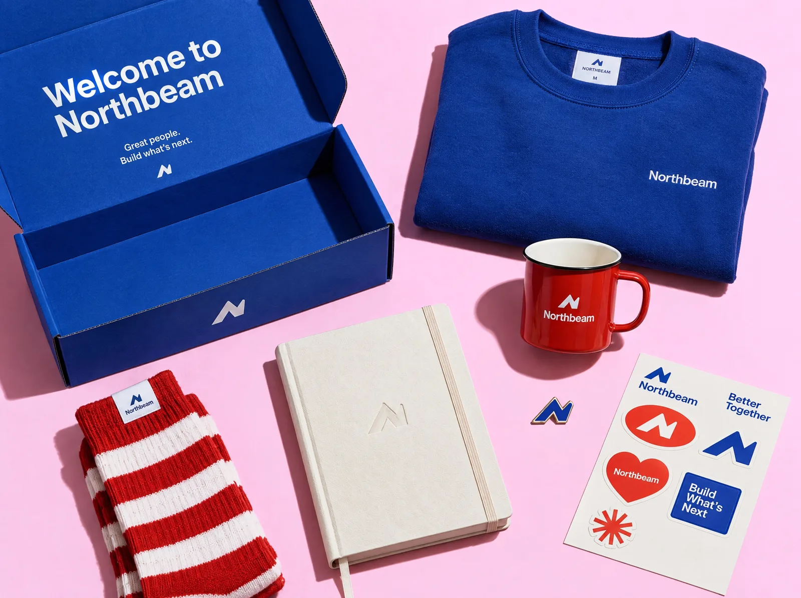 New hire welcome kit with a branded box, sweatshirt, mug, notebook and socks