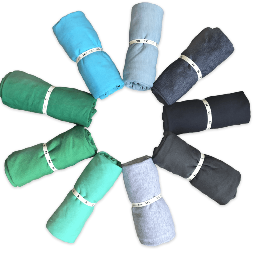 Spiral of neatly packed t-shirts you can print your logo on and use for t shirt dropshipping